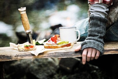 Foodfoto von Sandwich mit Messer auf Bank am Lagerfeuer. Foodfoto von Sandwich mit Messer auf Bank am Lagerfeuer.